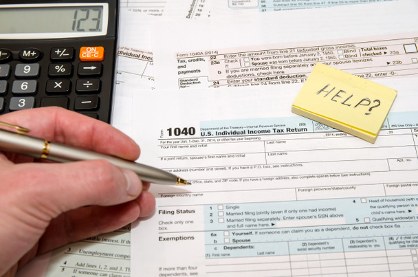 Tax Form 1040, U.S. Individual income tax return place with calculator and pen - Fotó, kép