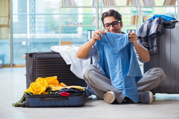 Young man preparing for vacation travel - 写真・画像