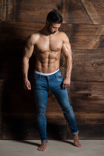 Portrait of Muscular Man Standing Near the Wall - Photo, Image