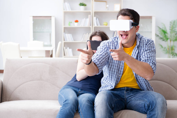 Young family playing games with virtual reality glasses - Valokuva, kuva