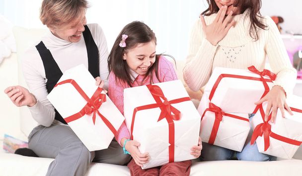 girl shares with the family with holiday gifts - 写真・画像