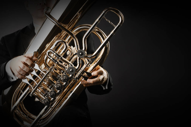 Tuba brass instrument hands closeup - Фото, изображение