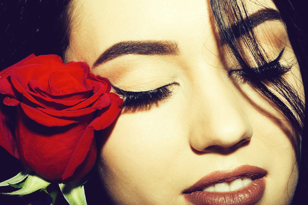Pretty girl with closed eyes and red rose - Photo, Image