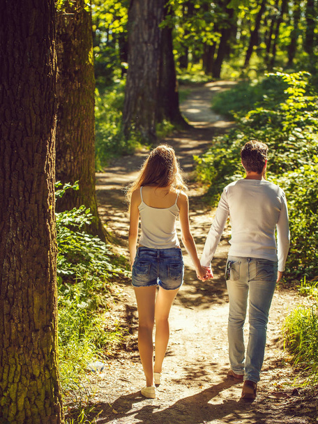 young couple walking in forest - Zdjęcie, obraz