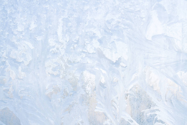 Winter frosty patterns on the frozen ice window - Photo, Image