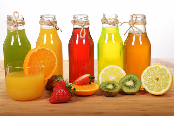a glass of freshly squeezed orange juice with colorful fruit jui - Foto, Imagem