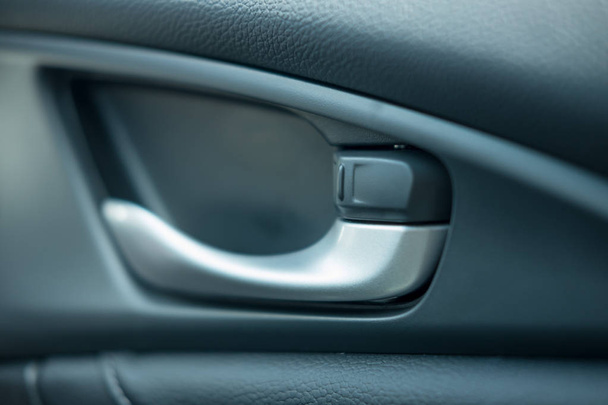 close up. car leather interior detail of door handle and lock up - Φωτογραφία, εικόνα