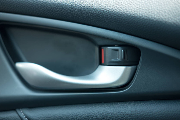 close up. car leather interior detail of door handle and lock up - Photo, image