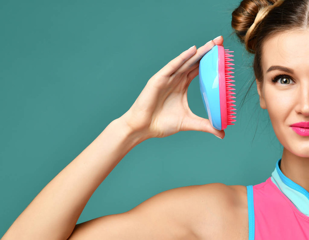 happy fashion brunette woman close eye with colorful pink blue popular hair comb brush - Photo, Image