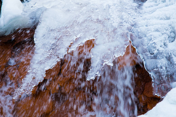 Red rock waterfall and  ice at Latvia. Travel photo. 2018 - Photo, Image