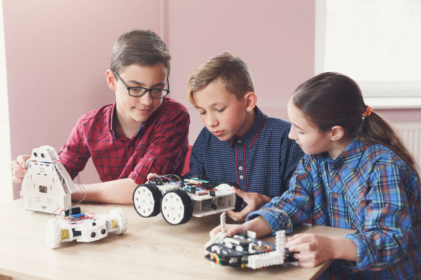 Stem education. Kids creating robots at school - Photo, Image
