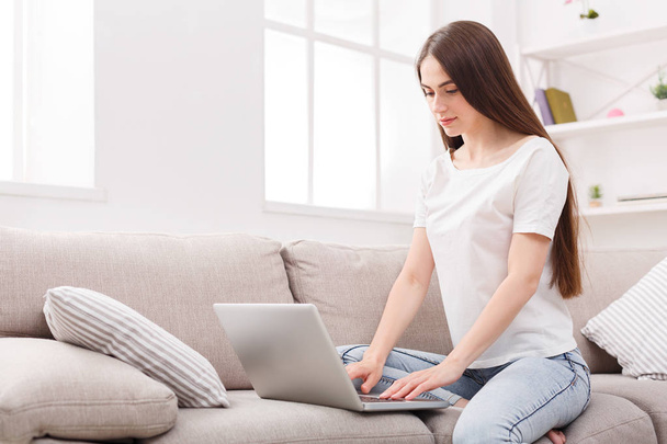 Girl with laptop on the sofa - Photo, image