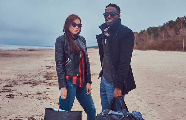 Portrait of an attractive stylish couple. An African-American man and Caucasian girl. - Foto, imagen