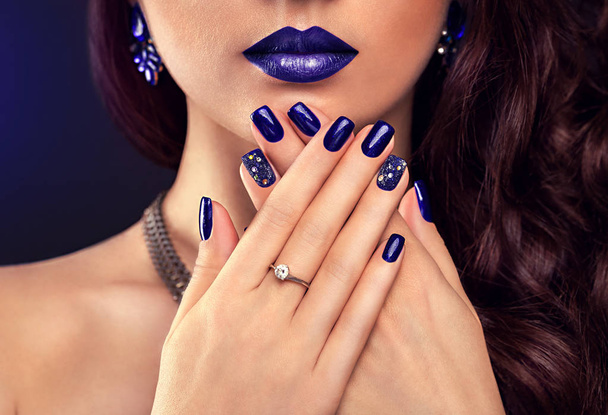 Beautiful woman with perfect make-up and blue manicure wearing jewellery - Photo, Image