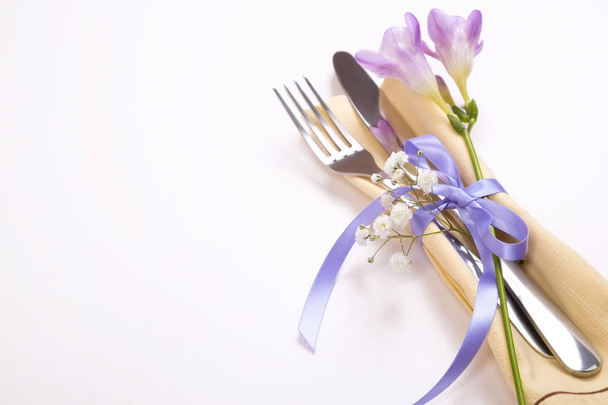 Easter laying table appointments, table setting options. Silverware, tableware items with festive decoration. Fork, knife and flowers. Happy easter holiday. - Photo, image