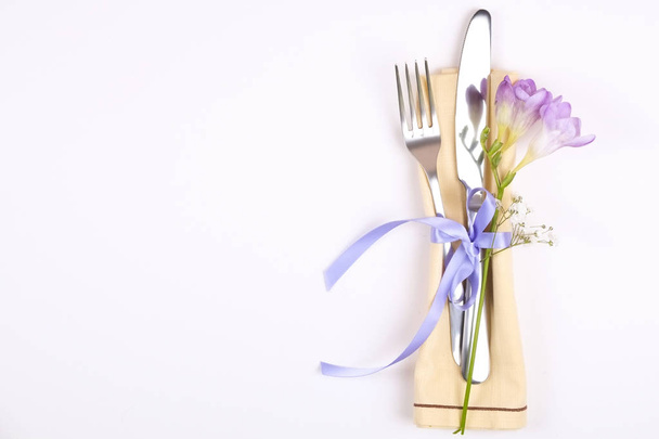 Easter laying table appointments, table setting options. Silverware, tableware items with festive decoration. Fork, knife and flowers. Happy easter holiday. - Фото, изображение
