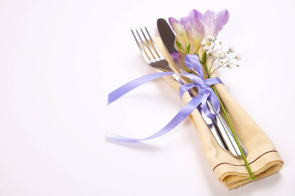 Easter laying table appointments, table setting options. Silverware, tableware items with festive decoration. Fork, knife and flowers. Happy easter holiday. - Fotografie, Obrázek