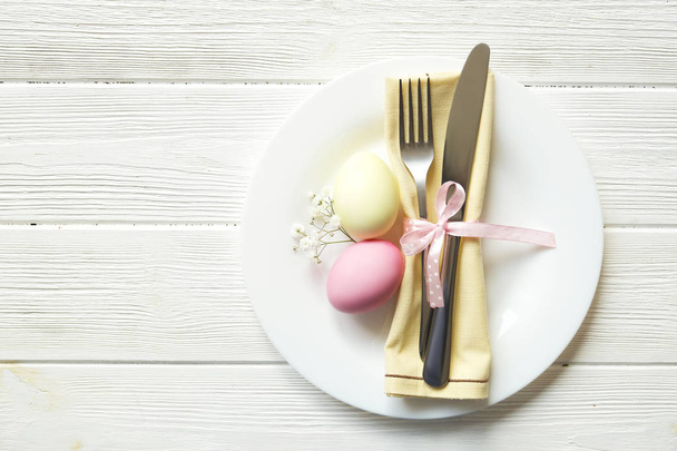 Easter laying table appointments, table setting options. Silverware, tableware items with festive decoration. Fork, knife and flowers. Happy easter holiday. - Foto, Bild