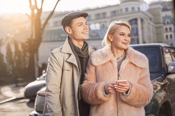 Optimistic lovers are enjoying time together in city - Foto, Bild