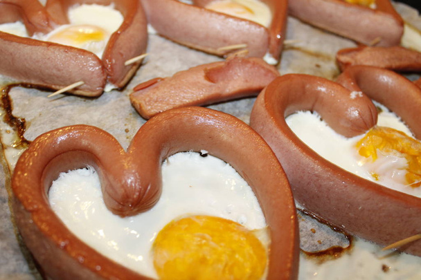 Fried egg in the wurstel sausage shape of heart - Photo, Image