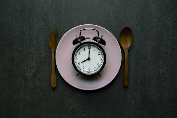 Food clock. Healthy food concept on wooden table - Photo, image