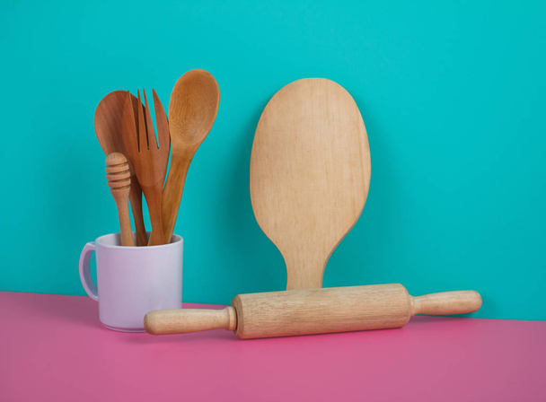 wooden kitchen utensils in white mug, rolling pin, and cutting b - Photo, image