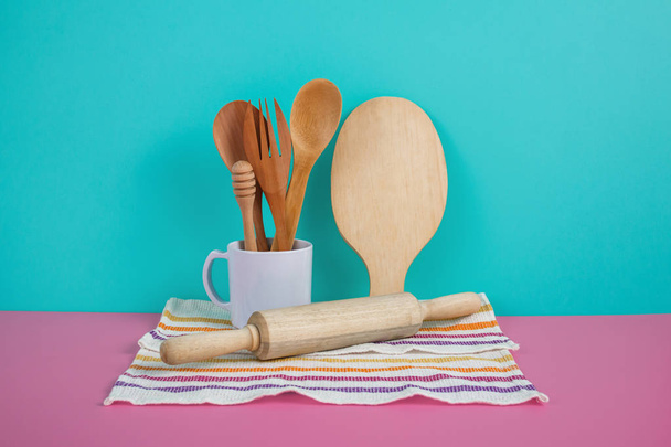 wooden kitchen utensils in white mug, rolling pin, and cutting b - 写真・画像