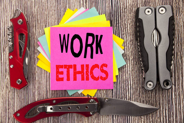 Writing text showing Work Ethics. Business concept for Moral Benefit Principles Written on sticky note wooden background with pocket knife - Photo, Image