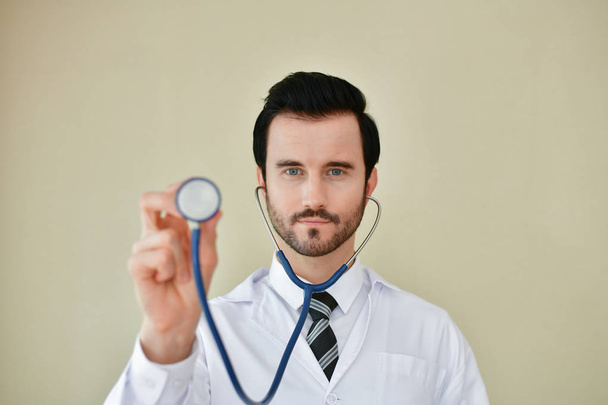 Smiling doctor posing in the office, he is wearing a stethoscope - Foto, Imagem