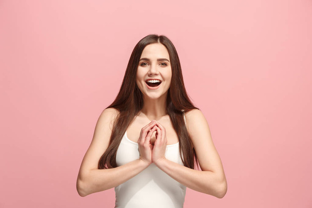 The happy business woman standing and smiling against pink background. - Φωτογραφία, εικόνα