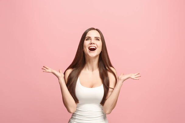 The happy business woman standing and smiling against pink background. - Foto, Imagen