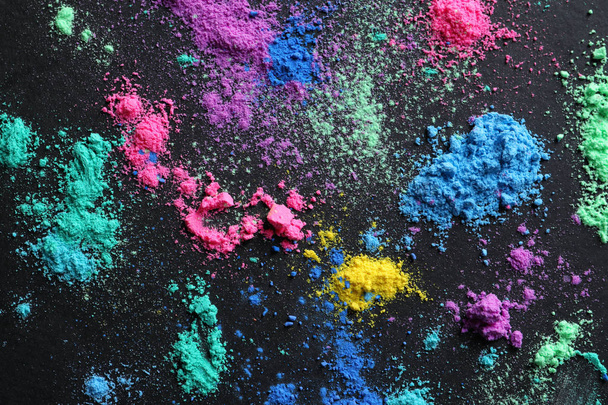 Colorful powders for Holi festival on dark background - Photo, image