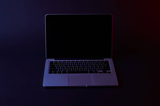 one turned off laptop with blank screen on dark - 写真・画像