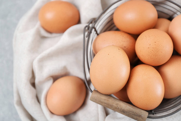 Metal basket with chicken eggs, closeup - Photo, Image