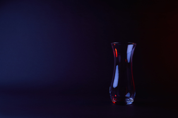 empty glass vase with reflection on dark surface  - Foto, Imagem
