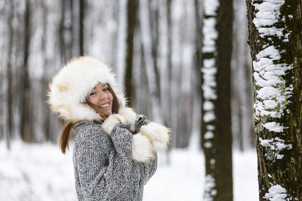beautiful young woman enjoying winter in the woods - Photo, Image