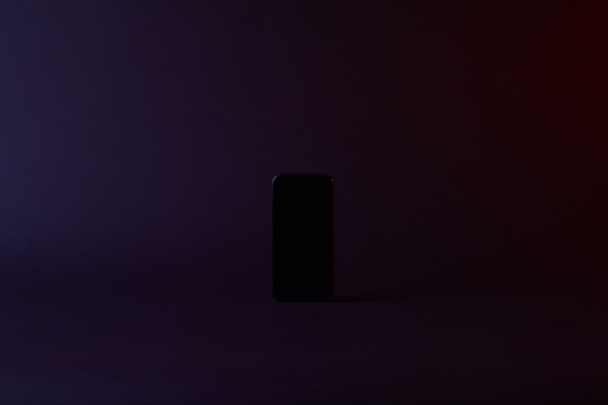 top view of one black smartphone on dark - Foto, Bild
