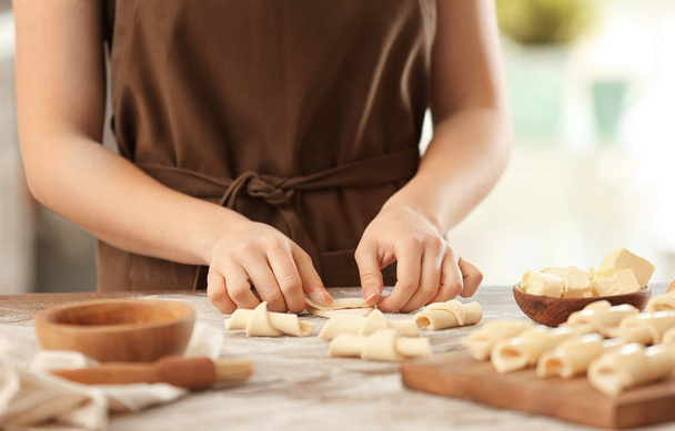 Woman preparing croissants in kitchen - Fotografie, Obrázek