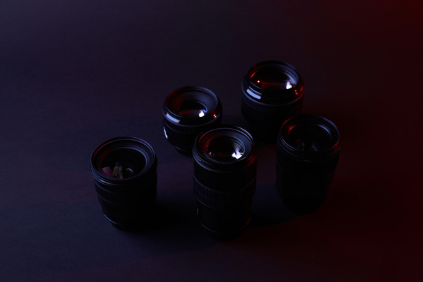 reflecting camera lenses on dark surface - Foto, Imagem