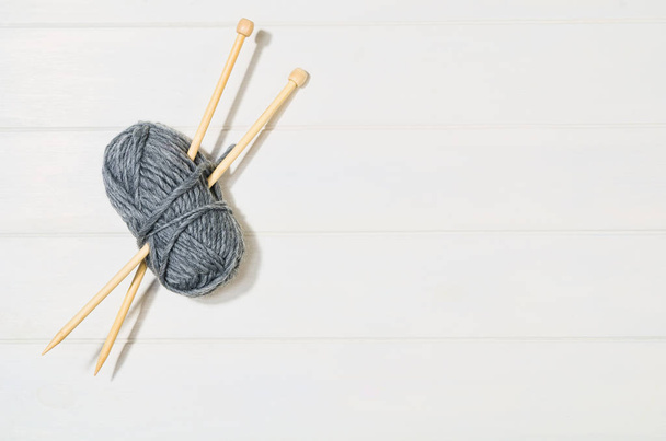 Knitting accessories top view on white wooden background - Valokuva, kuva