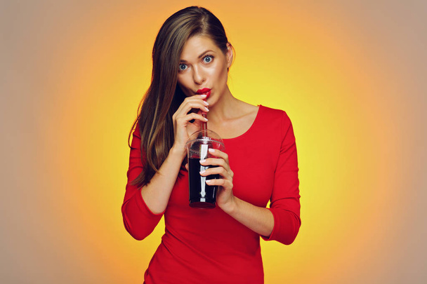 Woman drinking cola. Smiling girl wearing red  - Photo, Image