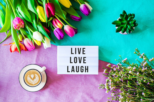 Live love laugh written in lightbox with spring flowers from abo - Zdjęcie, obraz