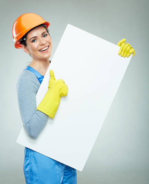 businesswoman builder showing thumb up and holding white advertising banner  - Photo, Image