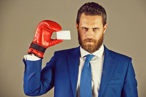 man holding credit card in business suit, red boxing glove - Zdjęcie, obraz