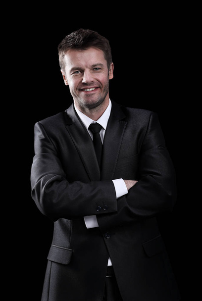 Happy business man arms folded isolated on black. - Фото, изображение