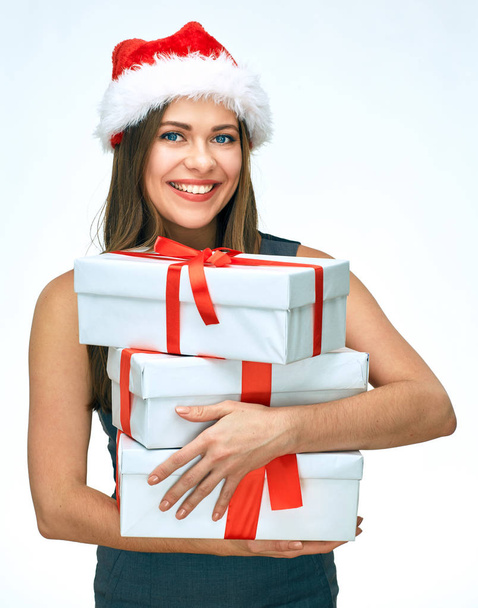 smiling businesswoman wearing Christmas Santa hat holding heap of gifts   - Фото, изображение
