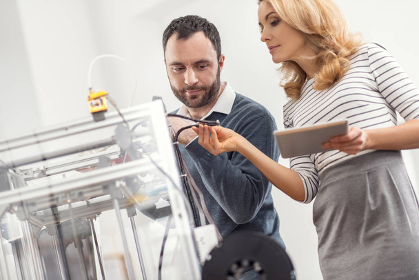 Female supervisor checking the quality of 3D printers wires - Foto, Imagem