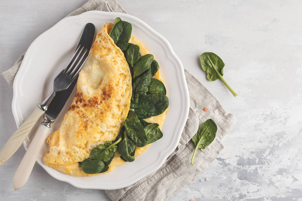 Omelette stuffed with spinach and cheese for a breakfast - 写真・画像