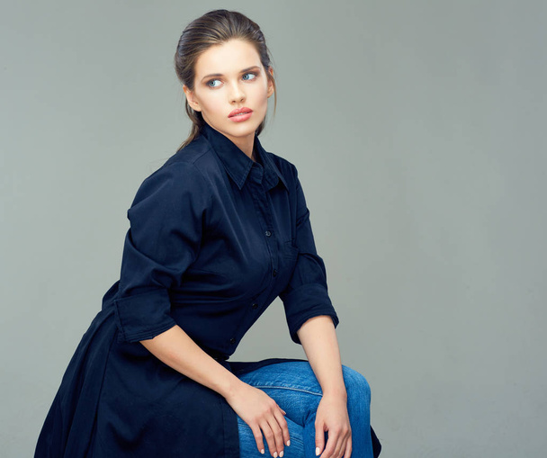 fashion style portrait of beautiful young woman in dark shirtdress on gray background - Fotoğraf, Görsel