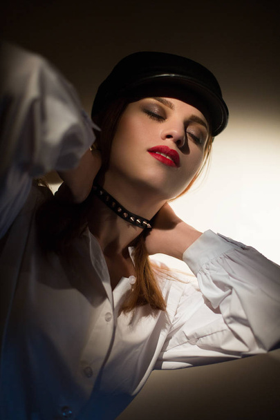 beautiful young girl in a cap and with a choker on the neck - Foto, afbeelding